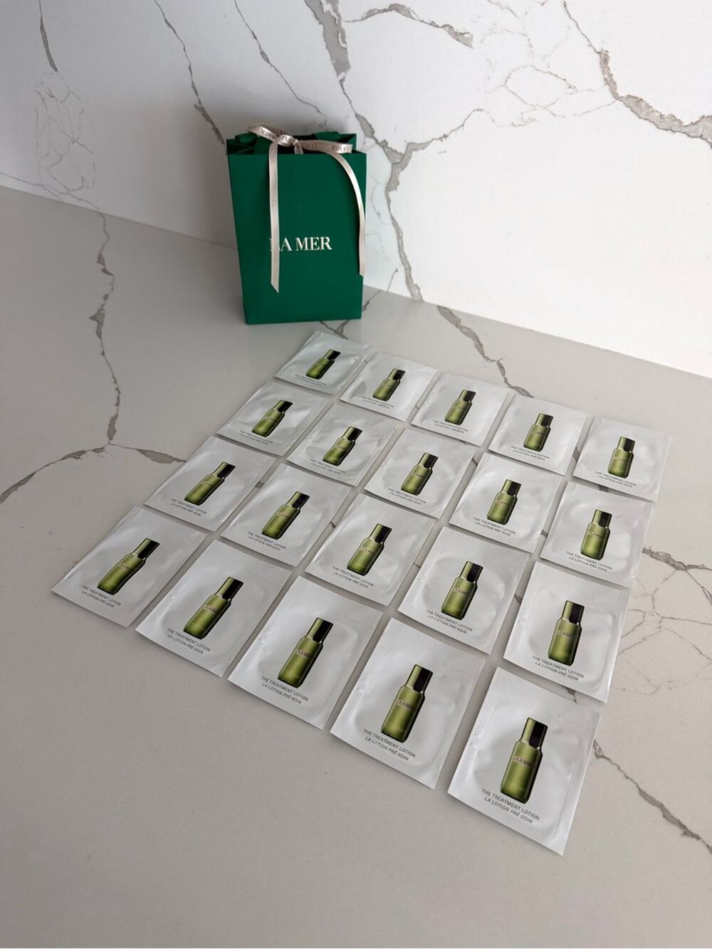 Authentic La Mer Treatment Lotion Single Use Sachets (Set of 20) and a Gift Bag